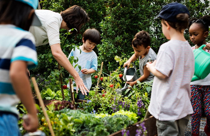 A group of school children gardening